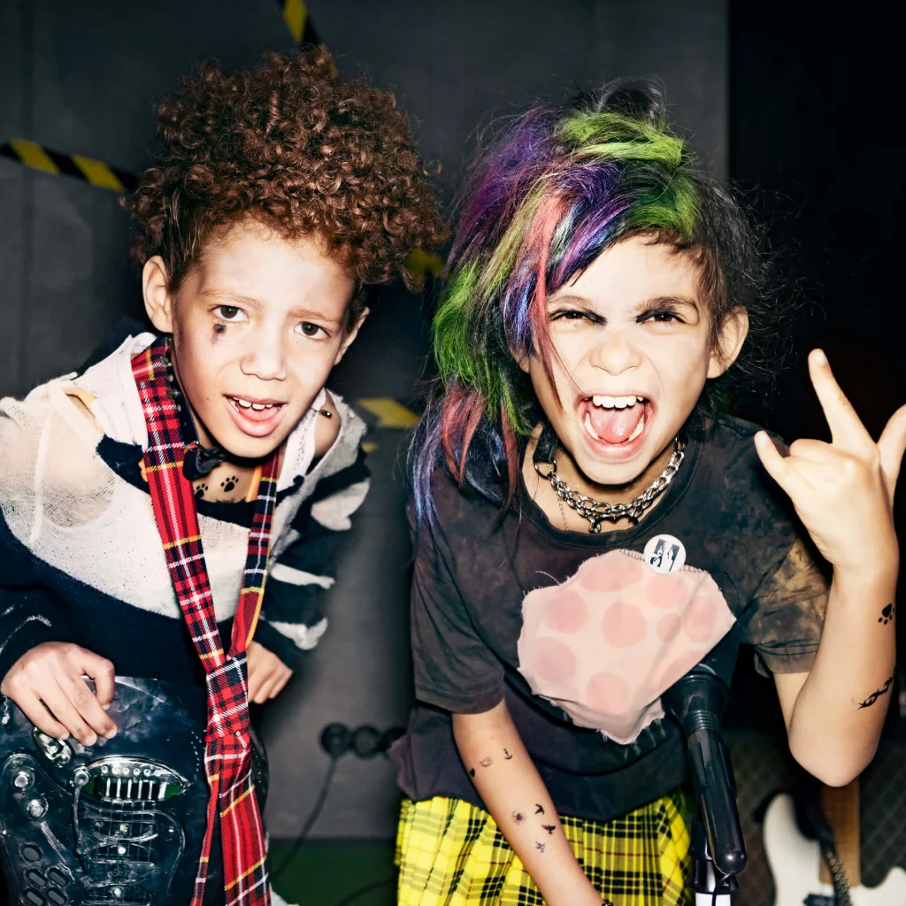 Two boys making hard rock sign with their hands.