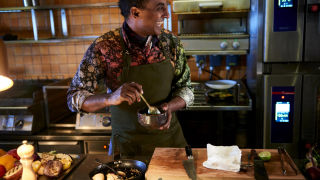 Marcus Samuelsson in the kitchen smiling_16_9