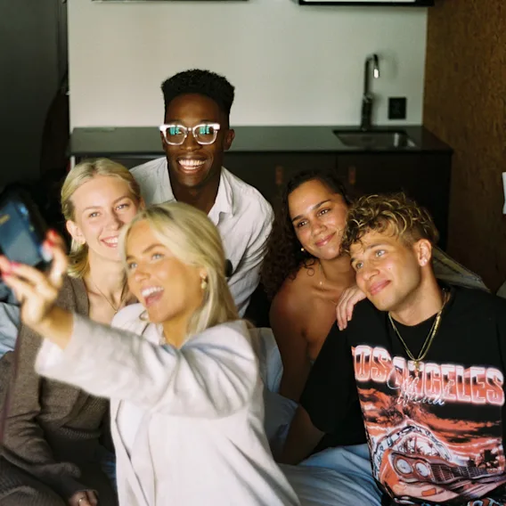 A group of people taking a selfie in bed at Comfort Hotel