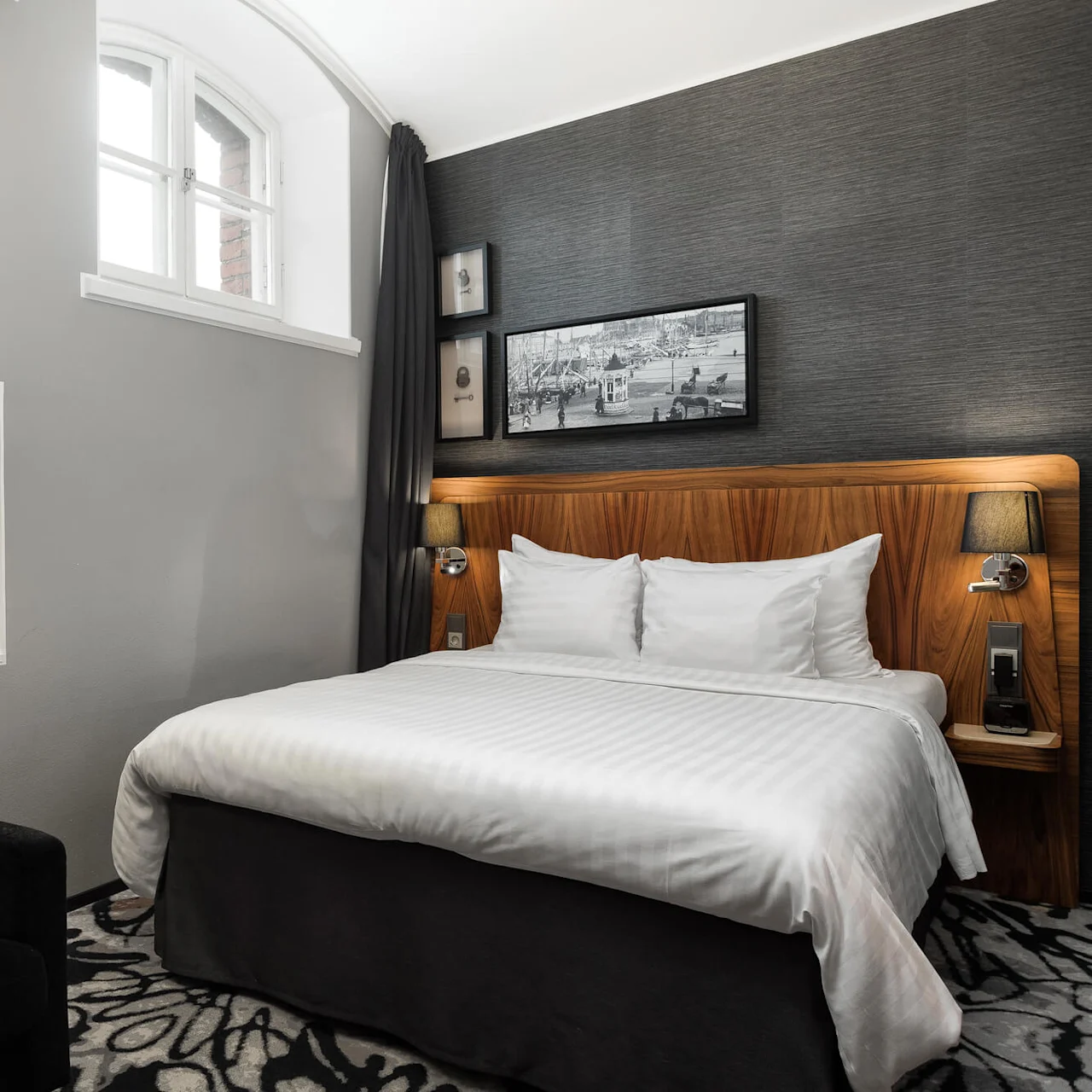 A bedroom with a neatly made bed, ambient lighting, and modern décor, set within an interior space.