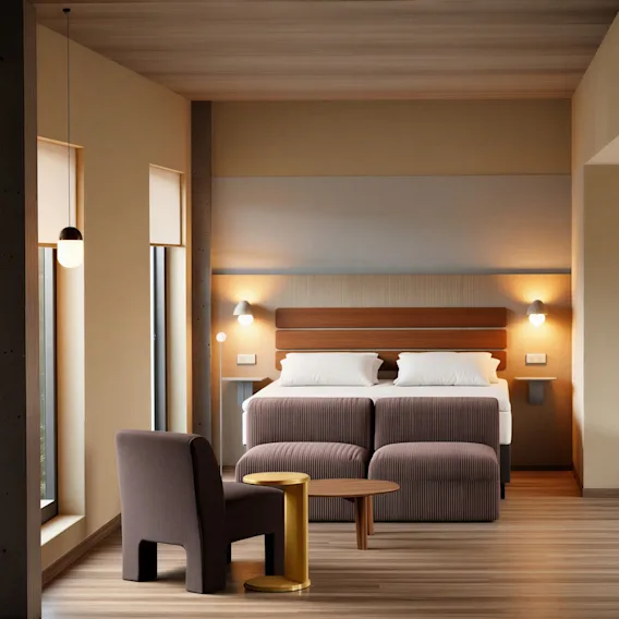 Et moderne og innbydende hotellrom med en komfortabel seng, et koselig sitteområde og varm belysning.
