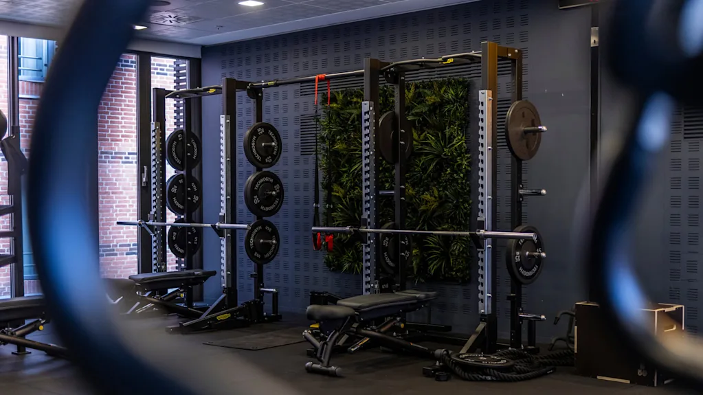 A workout area with two power racks equipped with weight plates and benches.