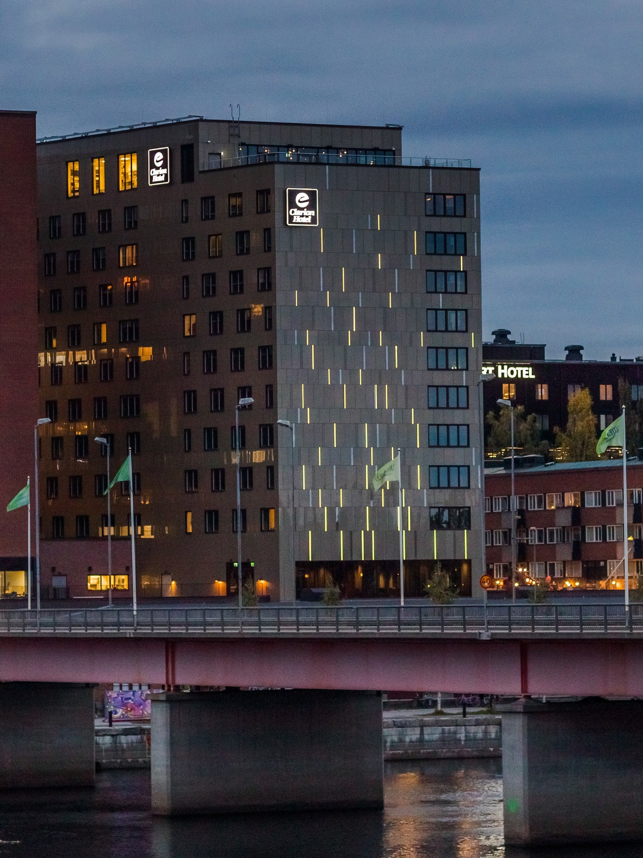 The facade of Clarion Hotel® Umeå at dusk. 