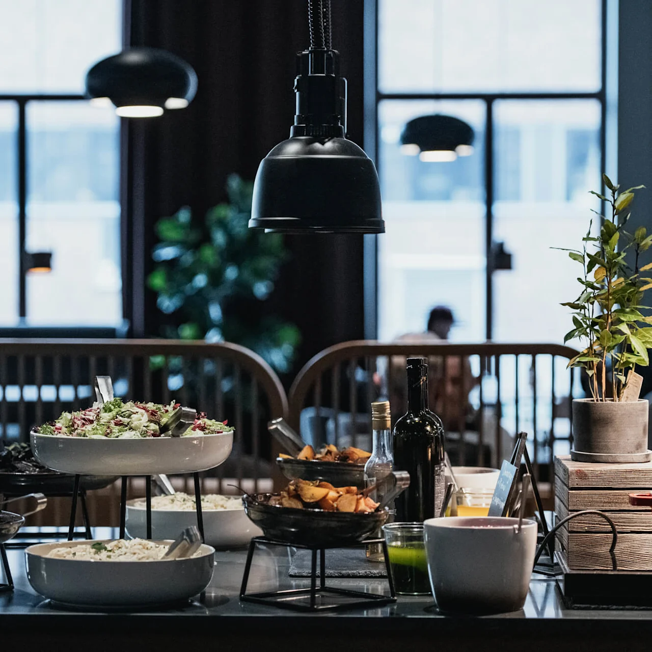 An assortment of dishes on a buffet, ambient lighting, warm and inviting restaurant setting.
