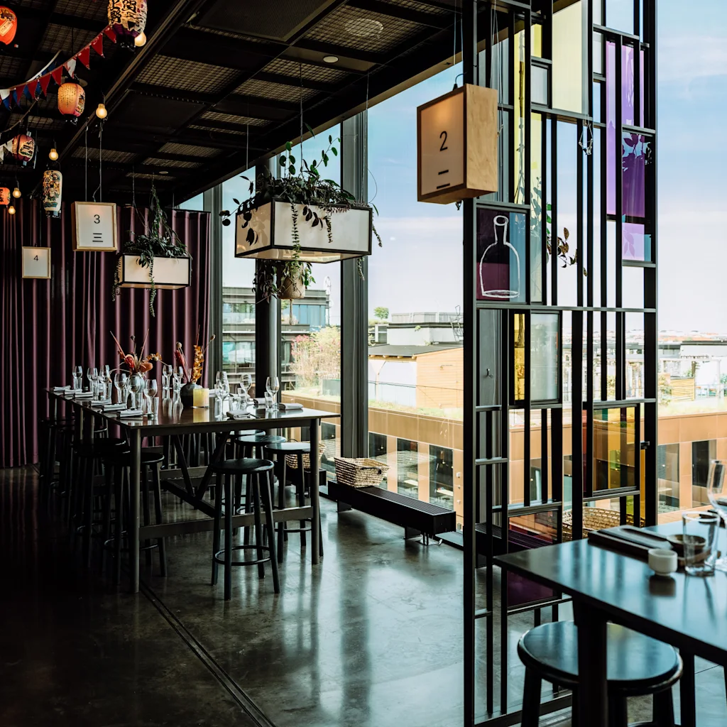TAK restaurant at Hobo in Stockholm. A modern dining space with set tables, city views, and decorative lanterns. Numbers 2, 3, 4.