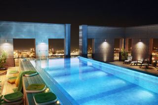 Swimming pool and lounge area on the roof terrace at Clarion Hotel Post