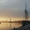 Cranes, a boat and the harbour in Gothenburg on a foggy morning.