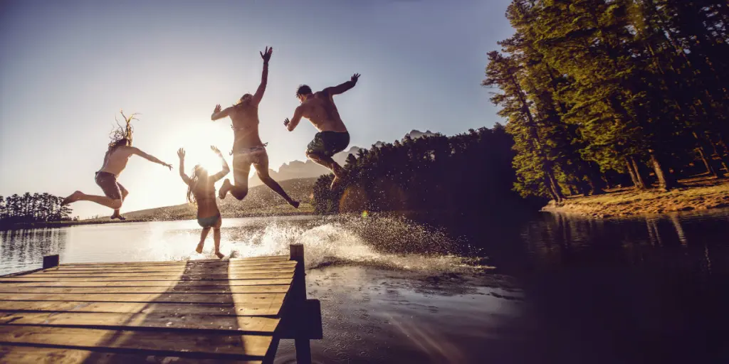 Friends jump in the water