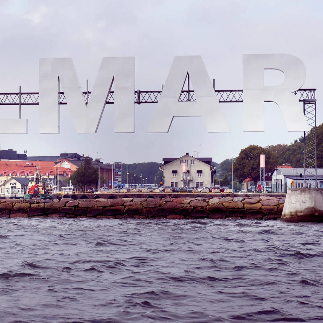 Large letters spelling "KALMAR" are installed above a waterfront scene with buildings and cloudy skies.