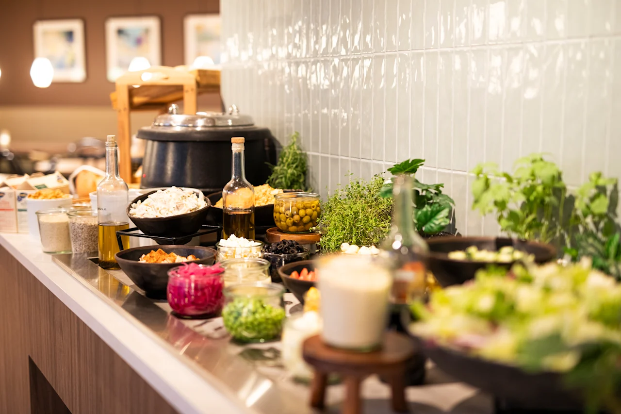 A vibrant buffet spread featuring a variety of fresh salad ingredients, dressings, and other delicious food options.