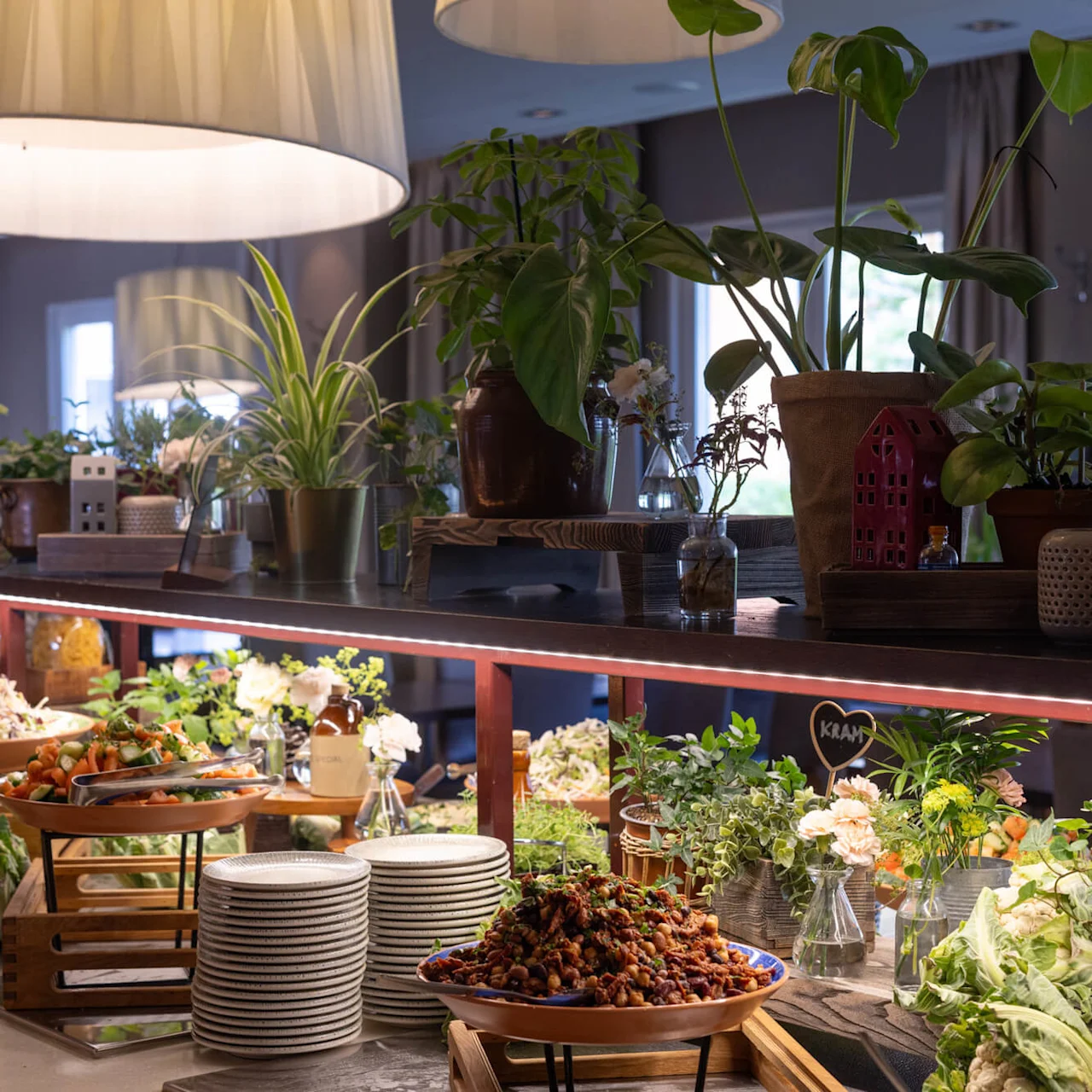 A buffet with various dishes under warm lighting offers a cozy dining atmosphere.