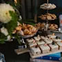 A delightful spread of pastries, including croissants, frosted cakes, and cookies, arranged on a table at Home Hotel Uppsala.