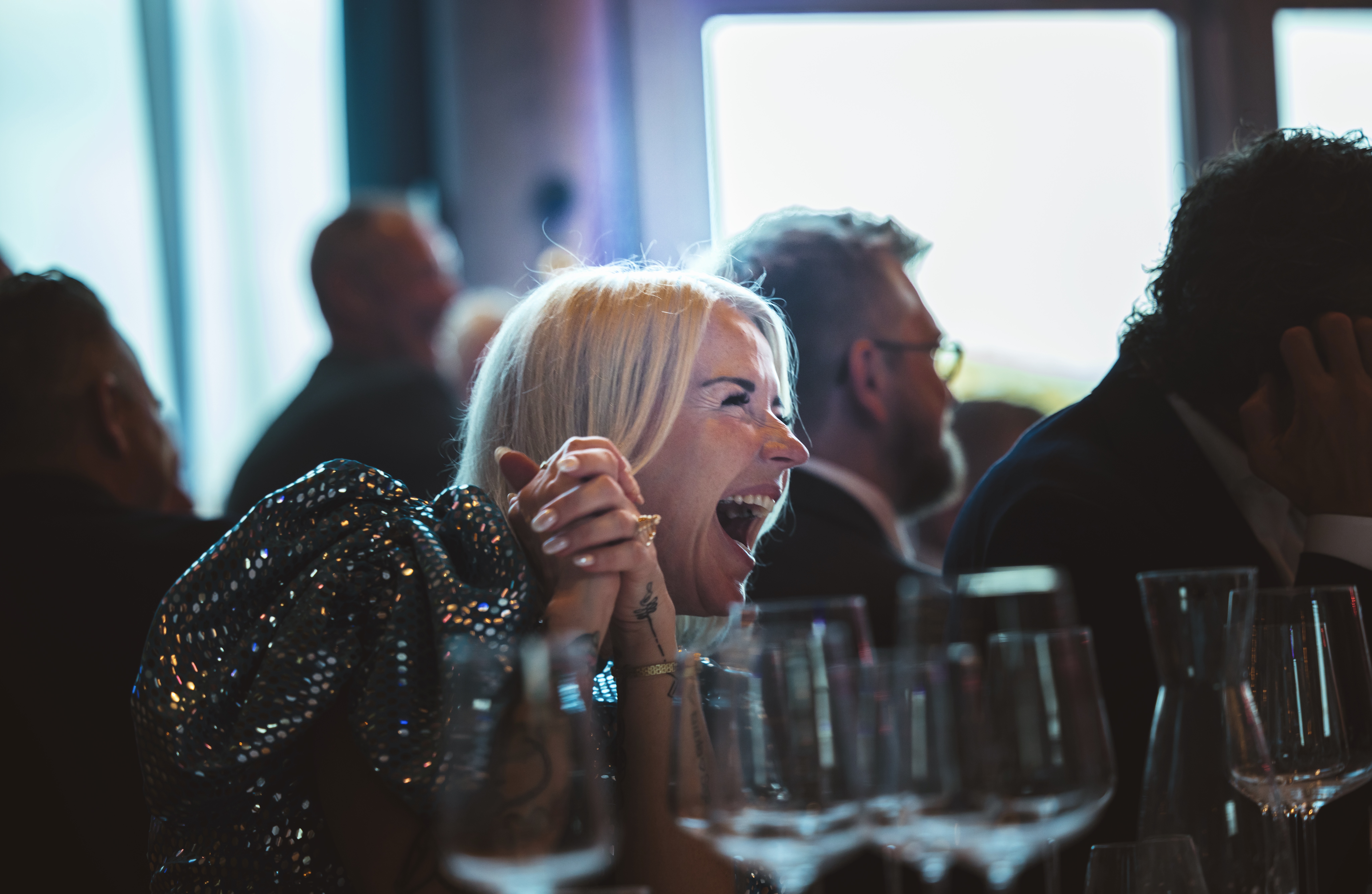 Woman laughing at a conference at Quality Hotel