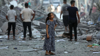Girl standing on the street amongst ruins - UNICEF_16_9
