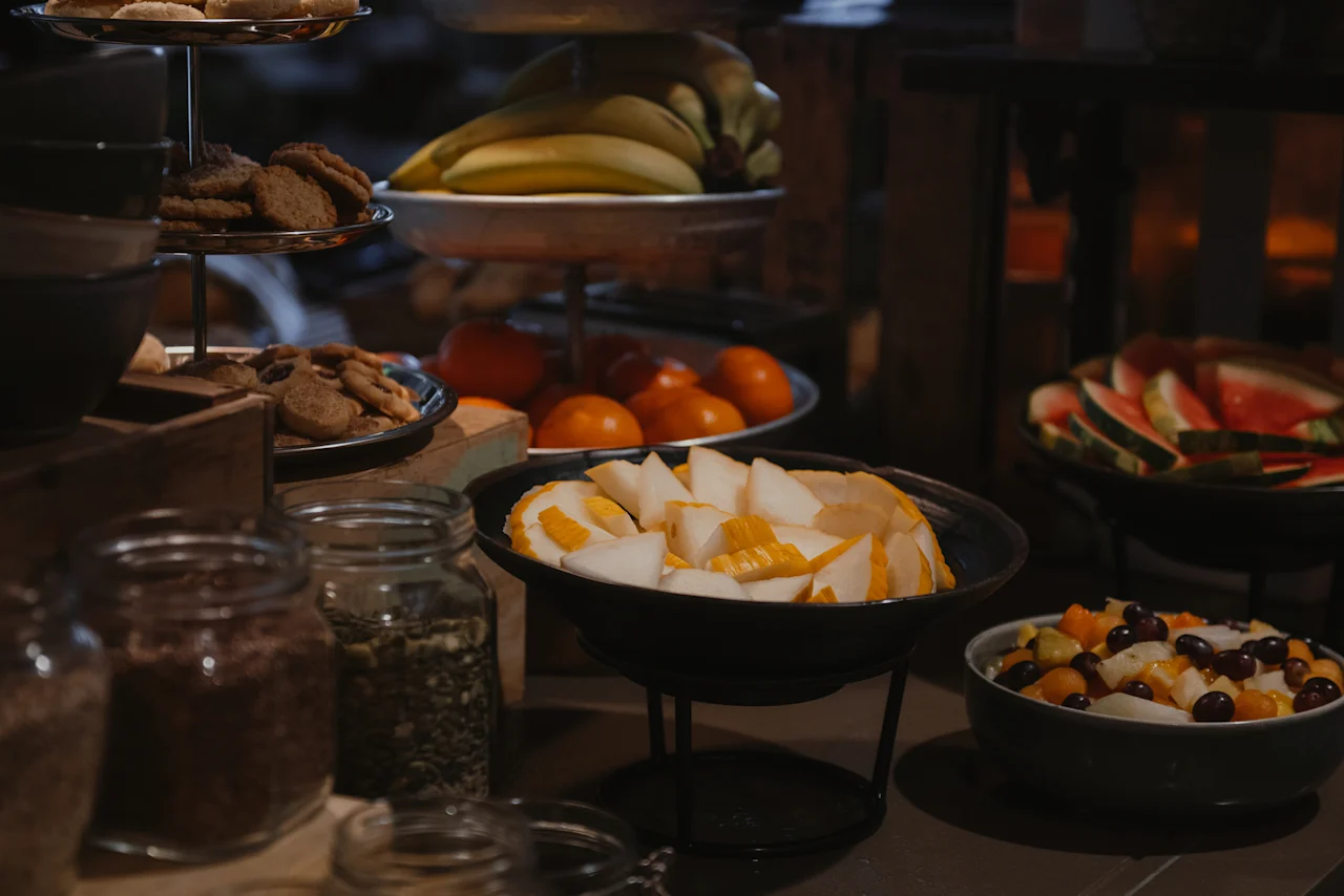 A delicious buffet spread at Home Hotel Uppsala, featuring fresh fruit, cookies, and various toppings for a delightful meal.