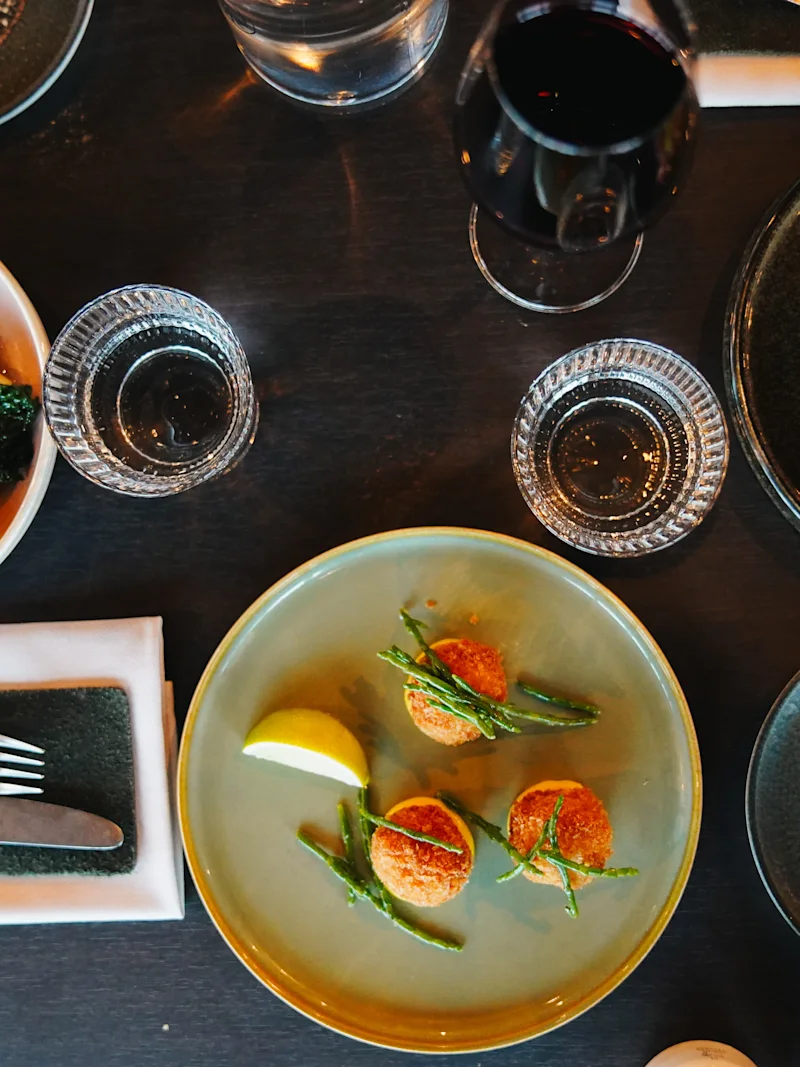 A beautifully set table at Clarion Hotel Umea with various gourmet dishes and drinks, ready for a delightful meal.