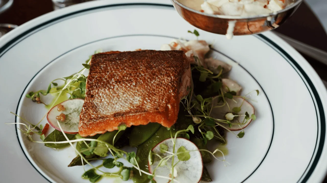 A fish dish served to a table at NÒR restaurant.