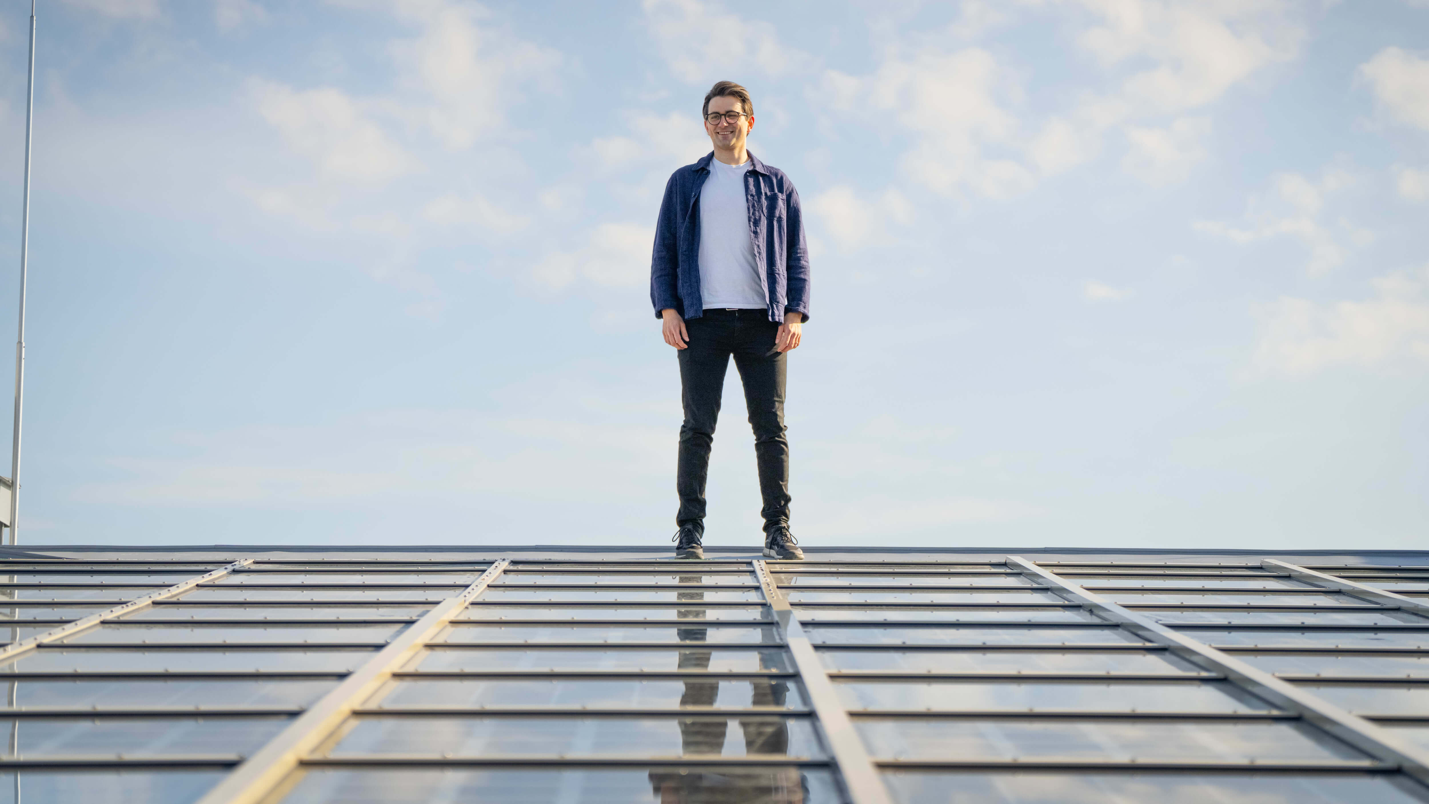 Sam, Hotel Manager, on the roof of Comfort Hotel Solna, solar panels.