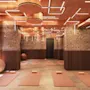 Modern yoga studio with brick walls, warm lighting, and mats laid out on the floor.