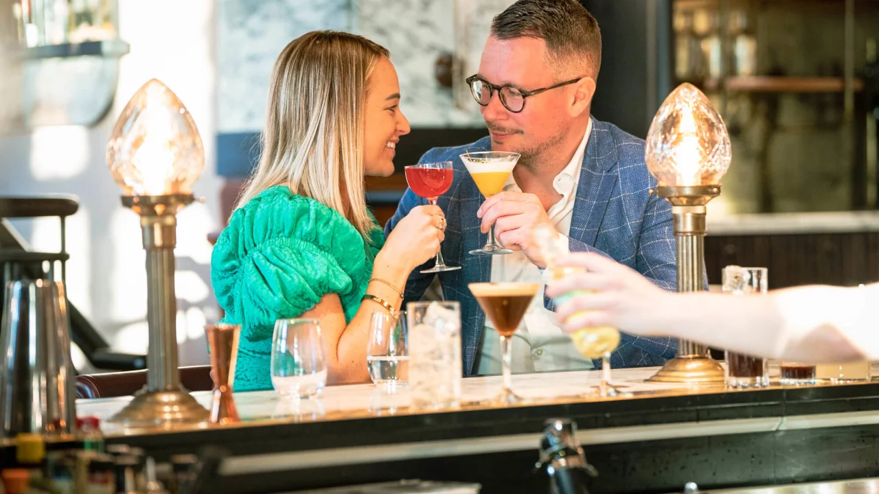A couple having drinks in the bar at hotel Villa Copenhagen.