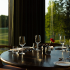  wine glass on set table in restaurant on table with golf course in background