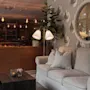 A cozy lounge area with a comfortable sofa, a warm fireplace, and bookshelves, creating an inviting atmosphere.