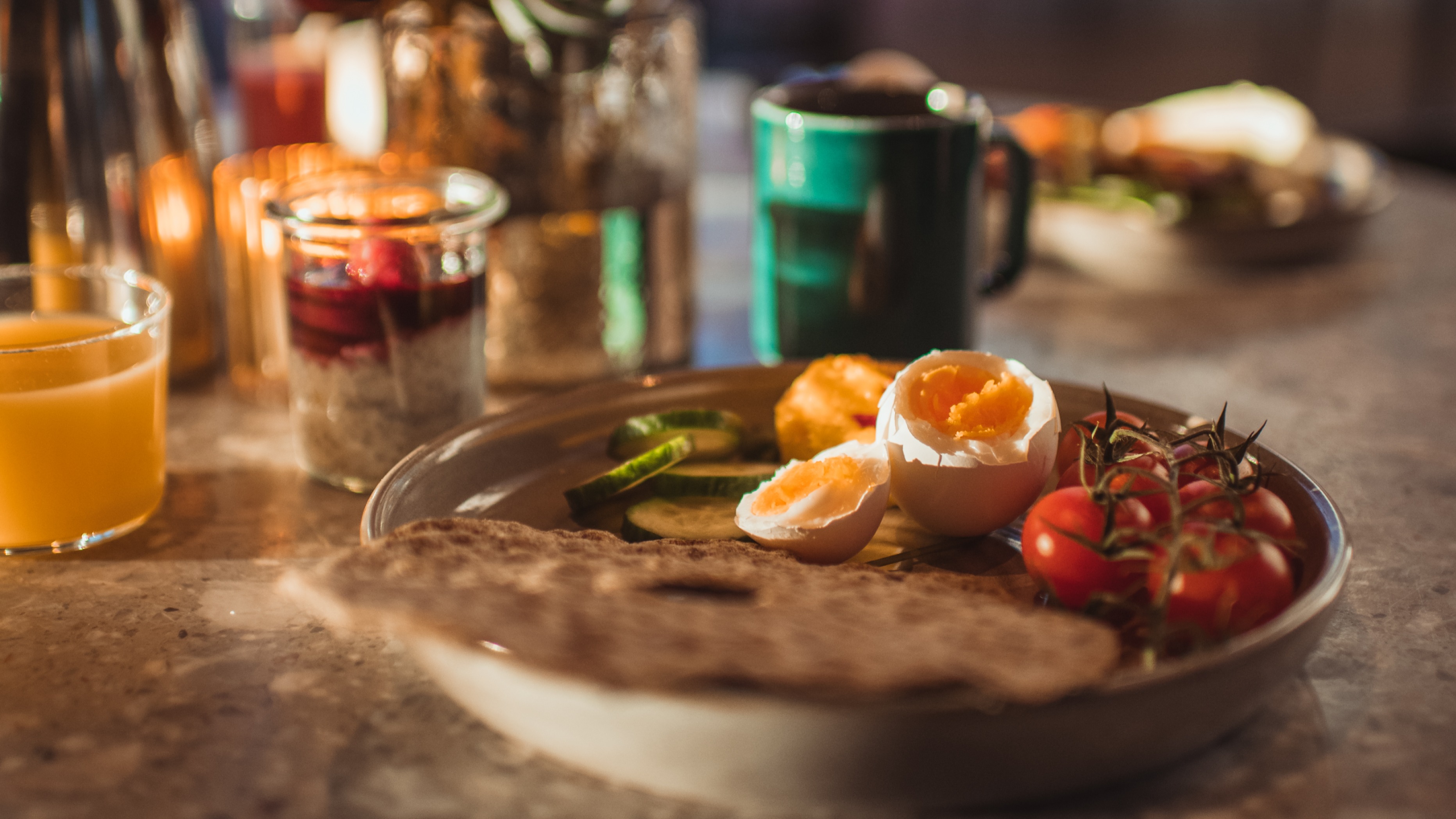 Plate with egg, crisp, tomatoes - orange juice and coffee cup