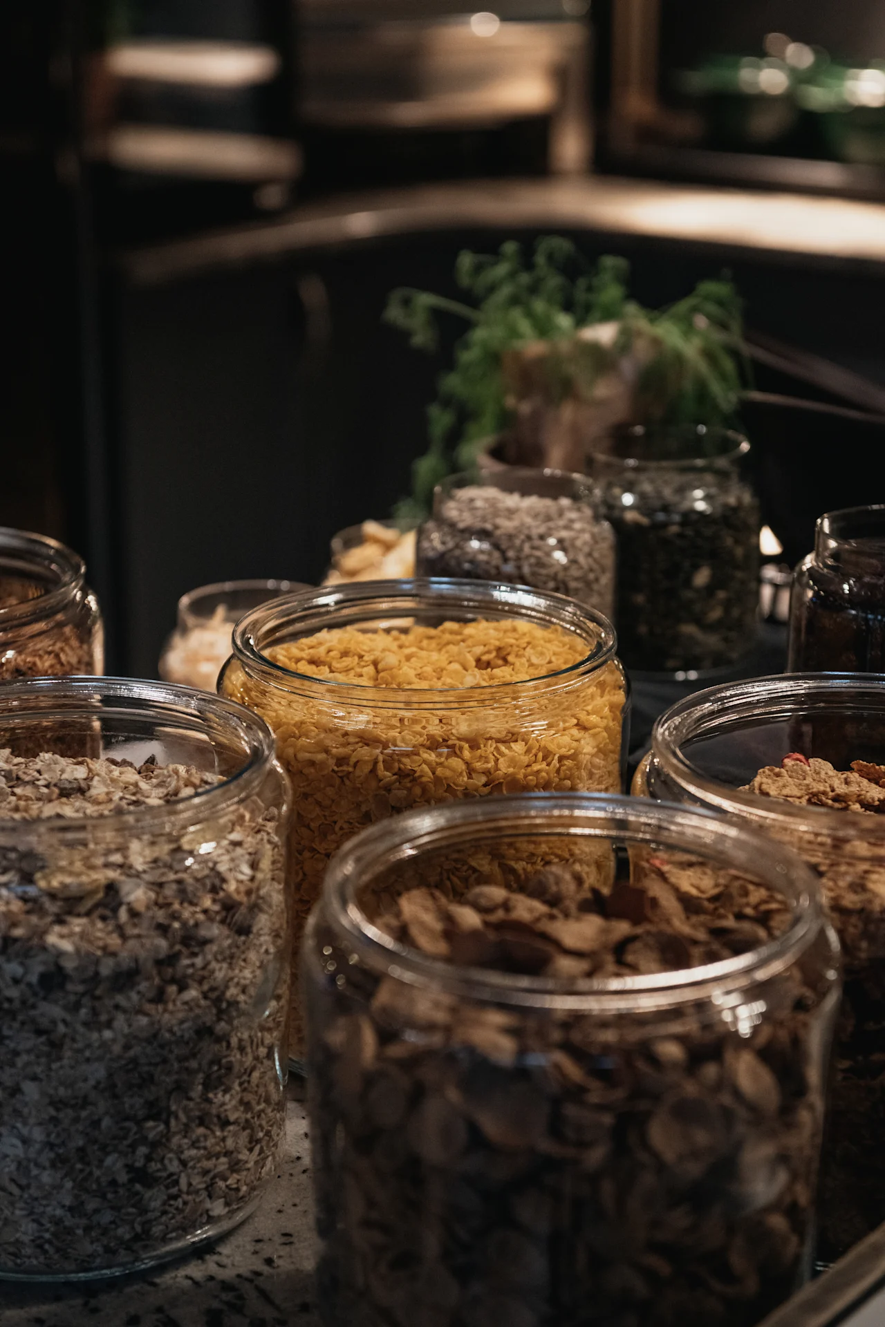 An inviting display of breakfast cereals, oats, and seeds in glass jars, ready for guests at Home Hotel Kung Oscar.