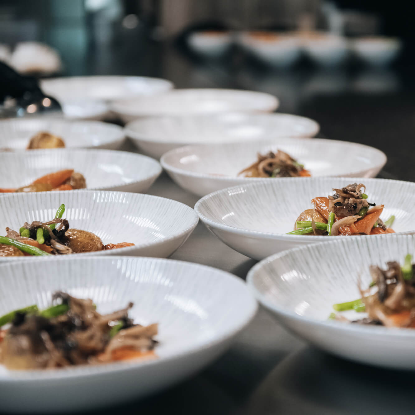 Colorful food plates lined up for serving at restaurant.