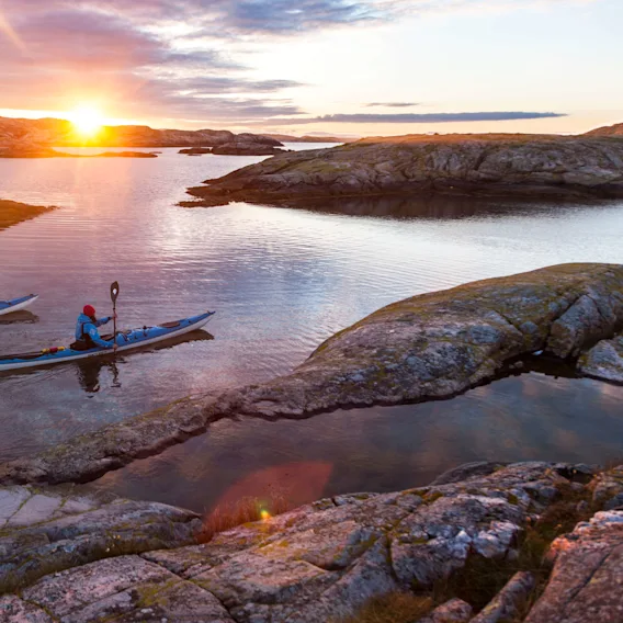 Two people kayaking in the sunset