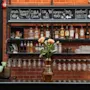 Et barområde med en menytavle som viser drikkealternativer som Irish Coffee, Cuba Libre, Gin og Tonic, Moscow Mule og Mocktail.