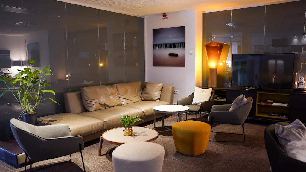 A cozy lounge area with modern furniture and warm lighting.