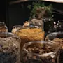 An inviting display of breakfast cereals, oats, and seeds in glass jars, ready for guests at Home Hotel Kung Oscar.