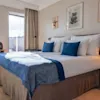 A bright and inviting hotel room at Quality Hotel The Book in Gothenburg, featuring a comfortable bed, desk, and city views.