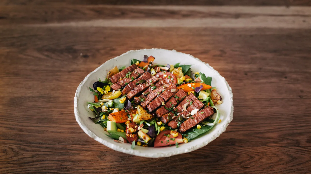 A plant-based steak salad in a bowl.