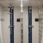 Home Hotel Kung Oscar: A clean and modern shower area with two shower heads, white and blue tiles, and glass block walls.
