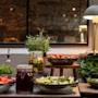 A vibrant buffet spread featuring fresh vegetables, pickled items, and condiments, ready for guests at Home Hotel Grand Bodø.