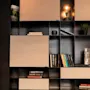 En moderne reol fyldt med bøger, en glødende lampe og et strejf af grønt, der antyder en behagelig læsekrog.
