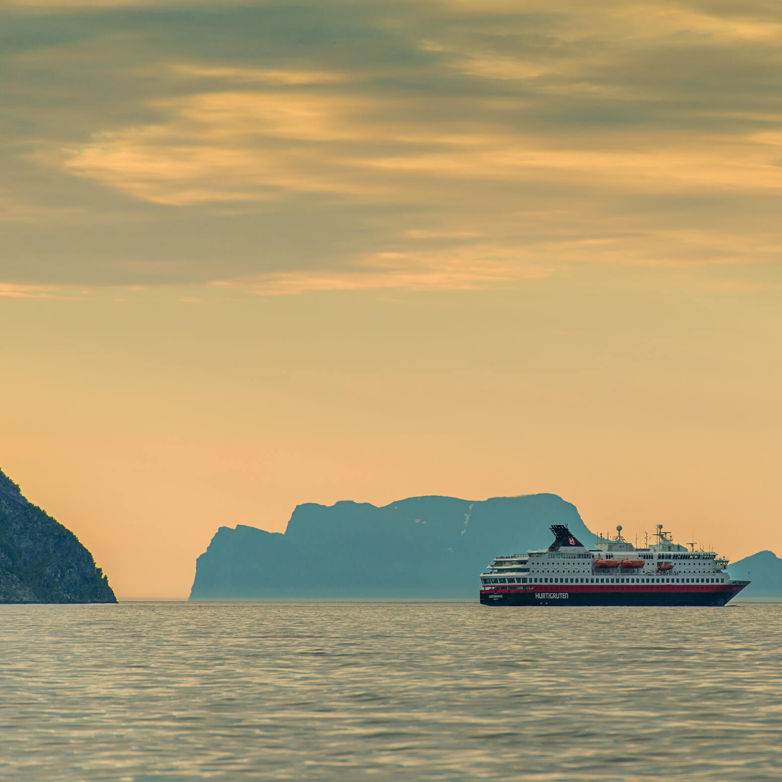 Hurtigruten ship at sea in sunset