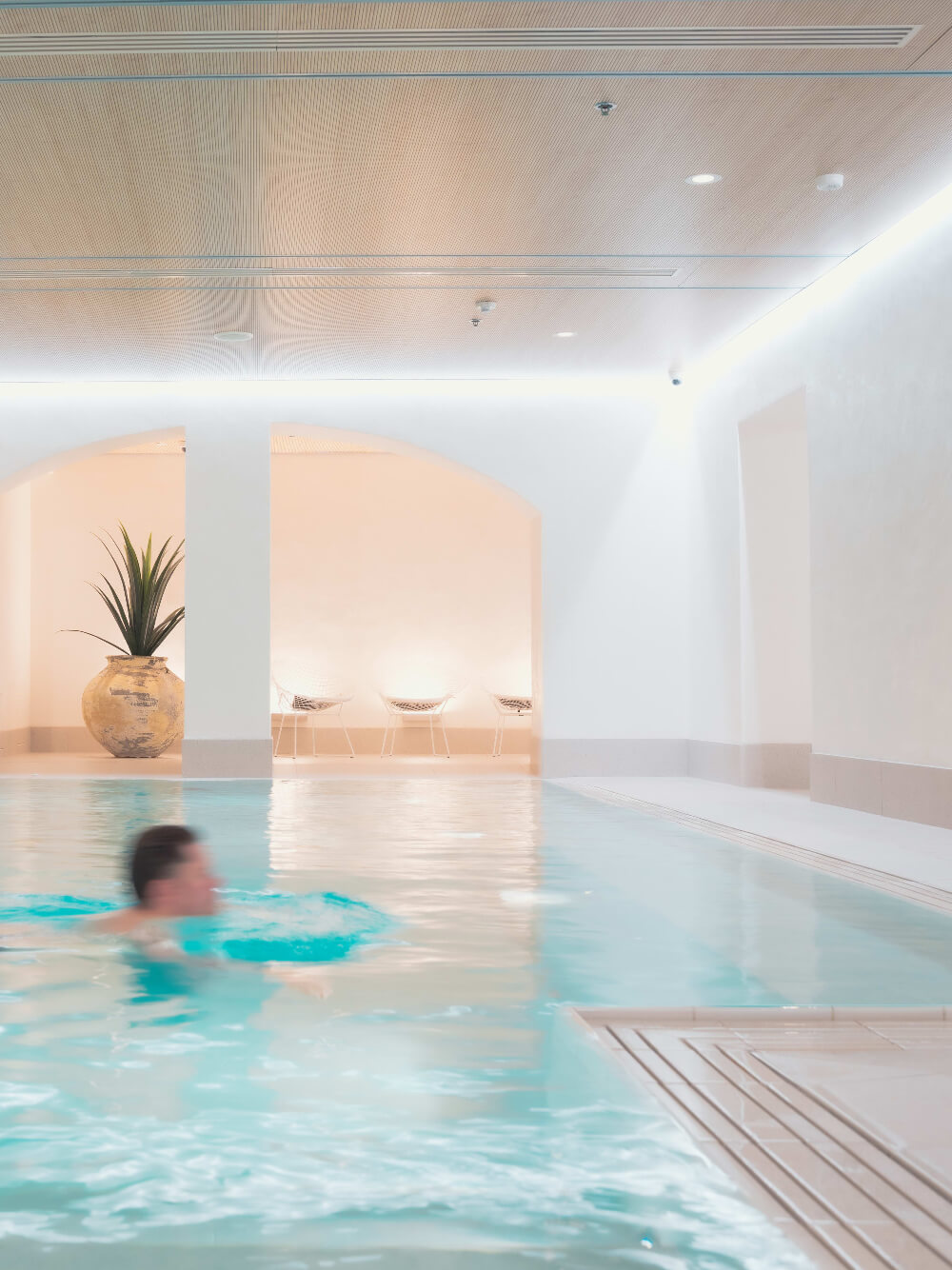 Man swimming in the pool at spa hotel St George in Helsinki.