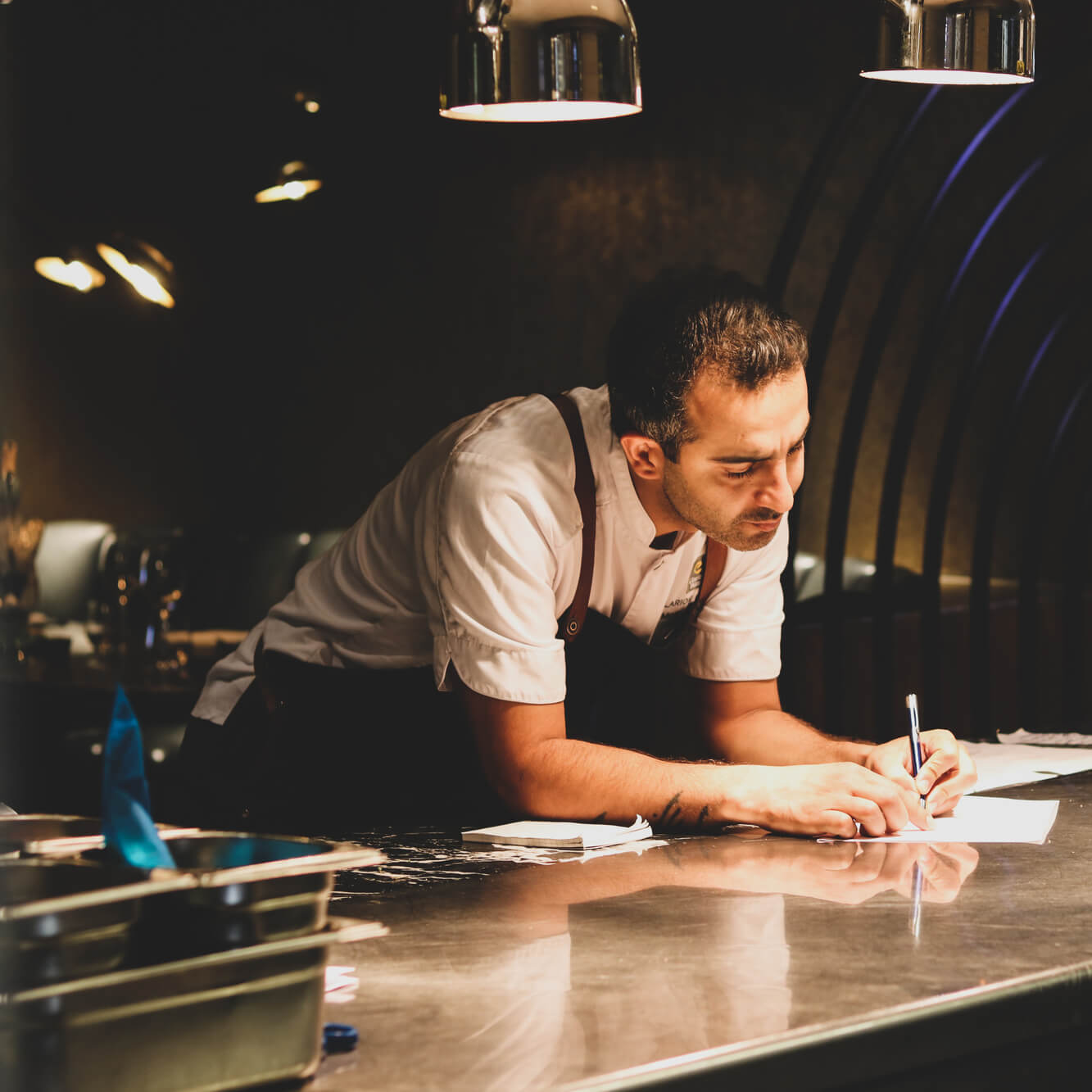 Chef taking order at restaurant in Oslo.