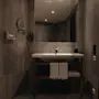 A well-appointed bathroom with a sink, mirror, and fresh towels, providing a comfortable space for personal care.
