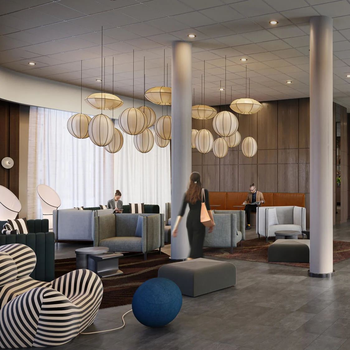 En moderne hotellobby har folk der går og sidder, med runde pendellamper og moderne møbler. Store vinduer og en receptionsdisk er synlige i baggrunden.