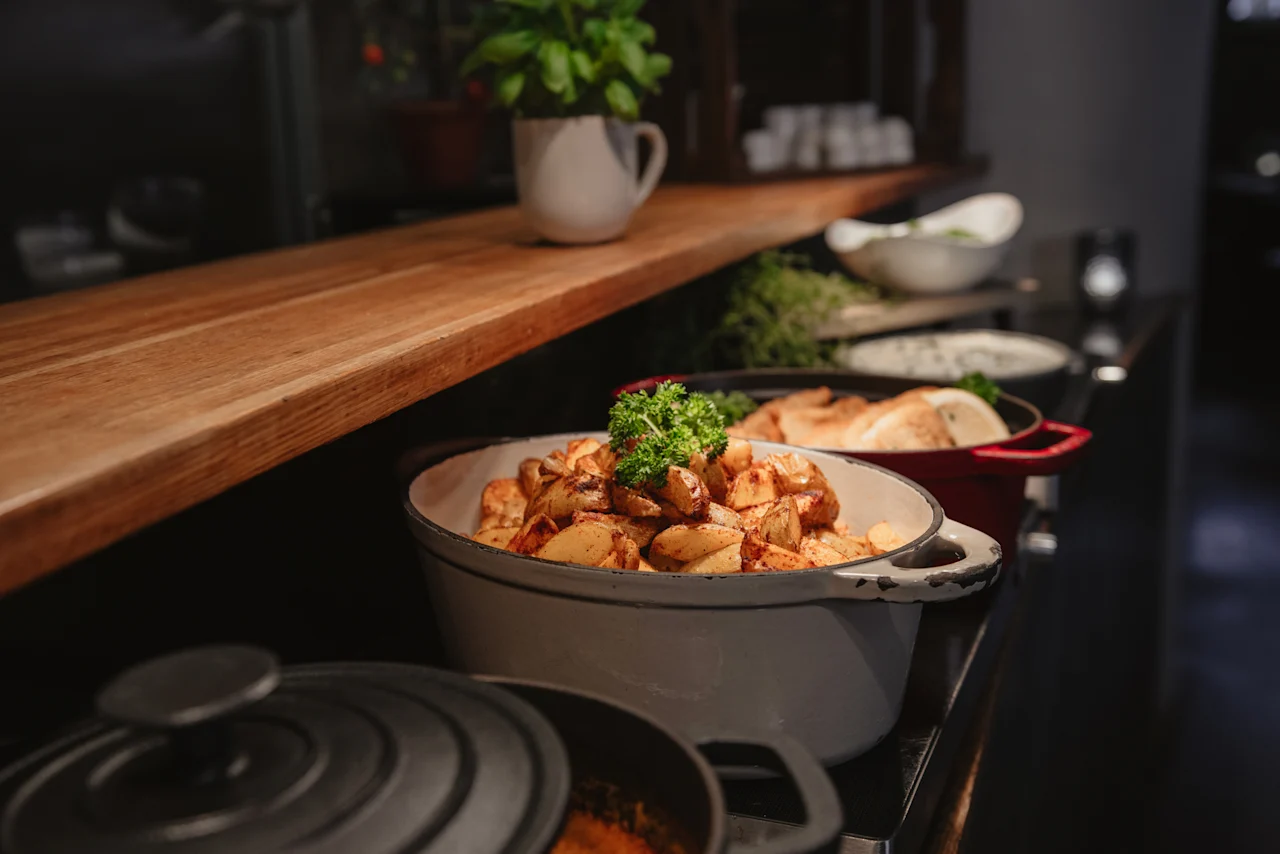 A delicious buffet spread at Home Hotel Uppsala, showcasing roasted potatoes and other warm dishes ready to be served.