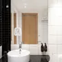 A modern bathroom with a white sink, a large mirror, and white and black tiled walls, reflecting a wooden door.