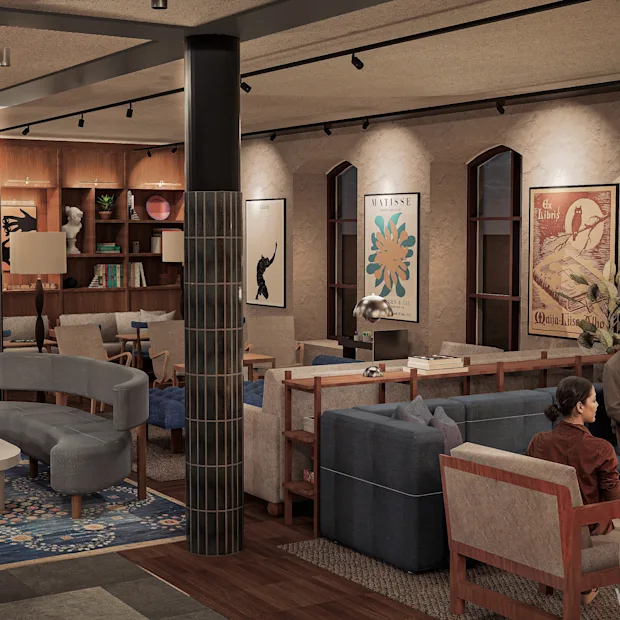 Et koselig salongområde med folk som slapper av i sofaer, omgitt av bokhyller og kunstverk. 