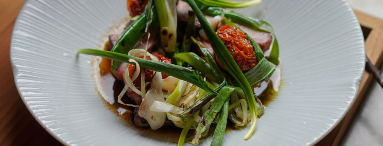 A delicious green food dish, served on a white plate.