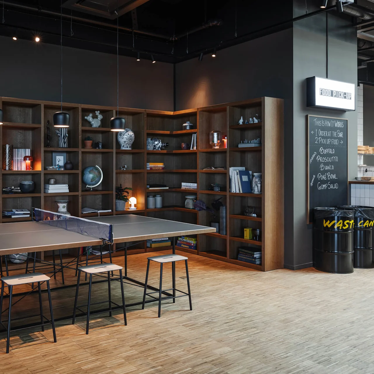 Ping pong table with stools is set in a modern room, surrounded by bookshelves filled with books and decorative items. On the wall: “FOOD PICK-UP”, “THIS IS HOW IT WORKS 1 ORDER AT THE BAR 2 PICKUP FOOD BUFALO, PROSCIUTTO, BIANCO, POKE BOWL, GUMP SALAD".