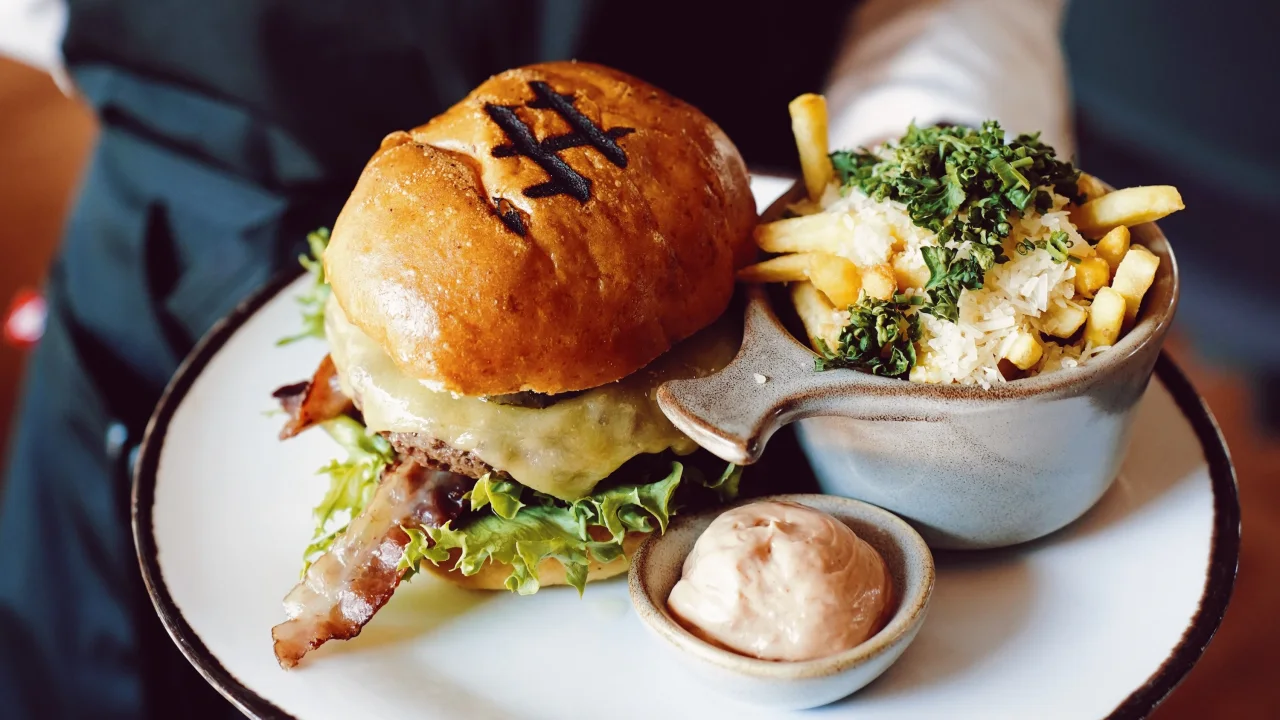 A burger and fries on a plate at The Social Bar & Bistro.