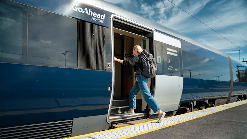 Woman entering a Go-Ahead train